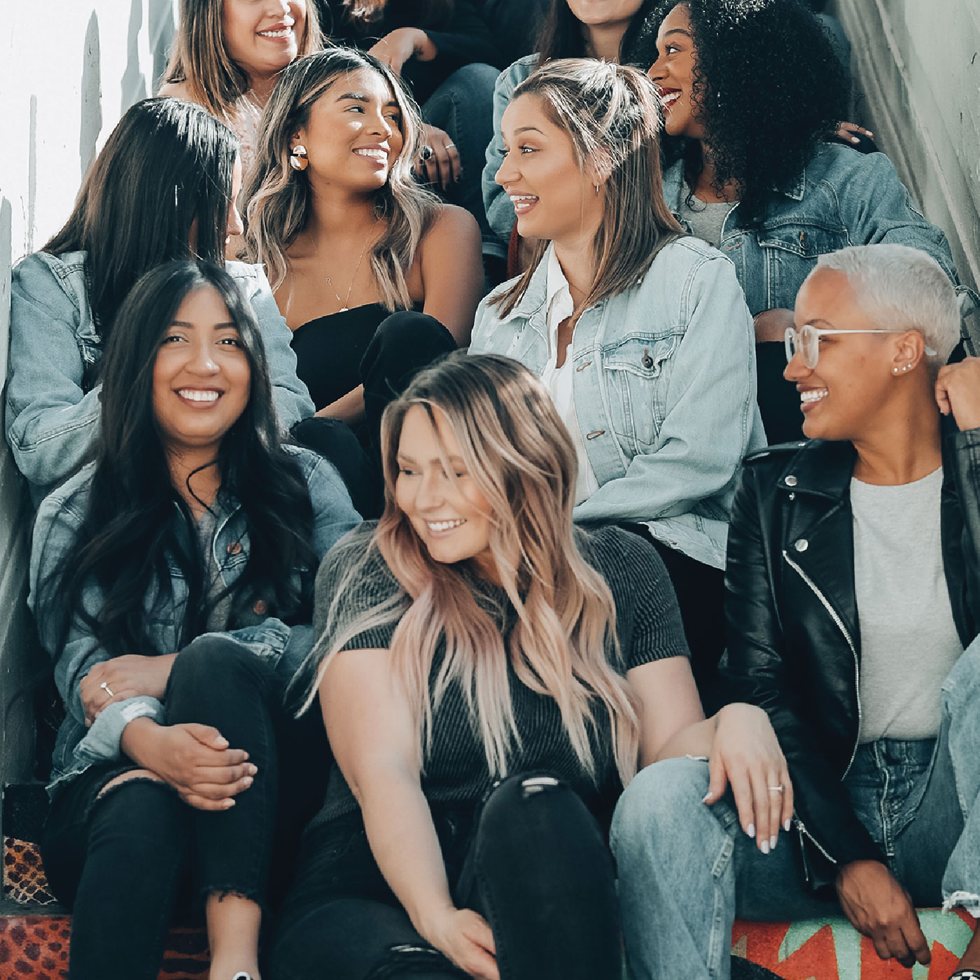 Group of college age girls sitting on a staircase together