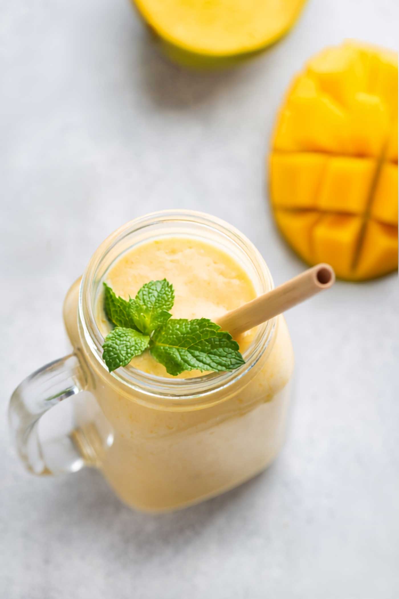 Overhead view of a creamy mango smoothie in a glass mug topped with fresh mint beside sliced mango. Photo 3 &mdash; Horizontal Mango Smoothie Photo Title: Easy Mango Protein Smoothie Recipe Pinterest Title: Easy Mango Protein Smoothie in 10 Minutes Pinterest Description: Looking for a quick breakfast or snack? This Mango Protein Smoothie combines frozen mango, milk, vanilla protein powder, and ice for a creamy tropical drink that comes together in just 10 minutes. Alt Text: Mango smoothie in a handled glass jar with mint, a straw, sliced mango, and a folded green napkin. Photo 4 &mdash; Vertical Mango Smoothie with Napkin Photo Title: Refreshing Mango Smoothie Recipe Pinterest Title: Refreshing Mango Smoothie with Frozen Mango Pinterest Description: Cool down with an easy Mango Smoothie made with frozen mango, milk, protein powder, and ice. It&rsquo;s creamy, fruity, full of tropical flavor, and ideal for breakfast, after a workout, or as an afternoon pick-me-up. Alt Text: Creamy mango smoothie topped with mint in a glass mug beside sliced mango and a green napkin. Photo 5 &mdash; Mango Smoothie with Fruit at Base Photo Title: Homemade Mango Smoothie with Protein Pinterest Title: Homemade Mango Smoothie with Protein Powder Pinterest Description: This homemade Mango Smoothie with protein powder is a simple and refreshing way to start the day. Frozen mango creates a naturally creamy texture, while vanilla protein powder makes it a more satisfying breakfast or snack. Alt Text: Mango smoothie in a mason jar mug with fresh mint, a straw, and sliced mango arranged nearby. Photo 6 &mdash; Close-Up Mango Smoothie Photo Title: Thick and Creamy Mango Smoothie Pinterest Title: Thick and Creamy Mango Smoothie Recipe Pinterest Description: Make a thick and creamy Mango Smoothie with only four simple ingredients. Frozen mango, milk, vanilla protein powder, and ice create a refreshing tropical smoothie that&rsquo;s easy to customize and ready in minutes. Alt Text: Close-up of a creamy mango smoothie in a glass mug topped with mint and served with fresh mango. For the two similar upright photos, I varied the wording enough that you can use both without the titles and Pinterest descriptions feeling repetitive.