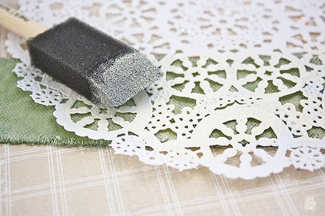 Stenciling (using a paper doily) onto the paint dipped drop cloth soap wraps!