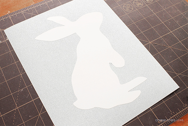 Applying bunny silhouette to the scrapbook paper.