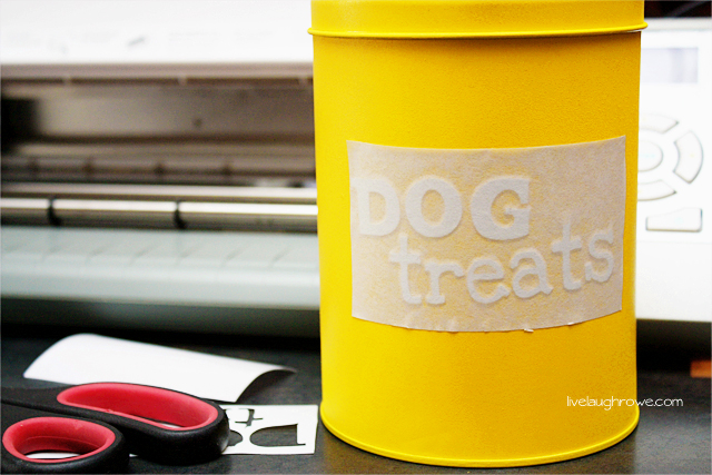 Applying dog treats vinyl to spray painted tin