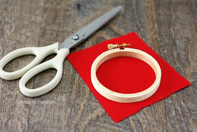 Cut fabric to fit the hoop for DIY Apple Hoop Art.
