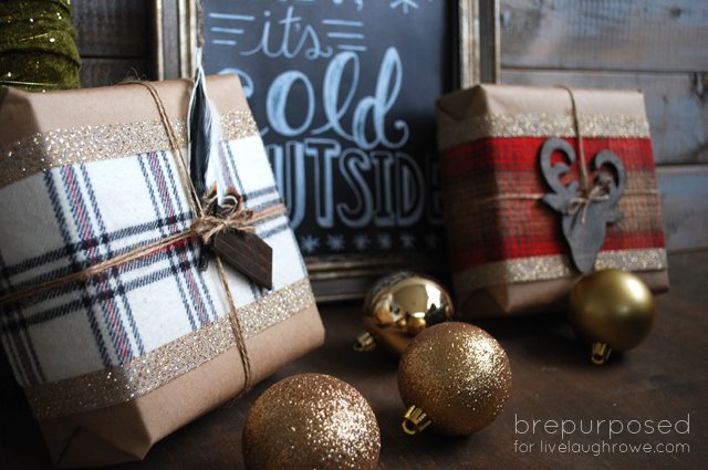 Stylish christmas gift wrapped in fabric on rustic table with