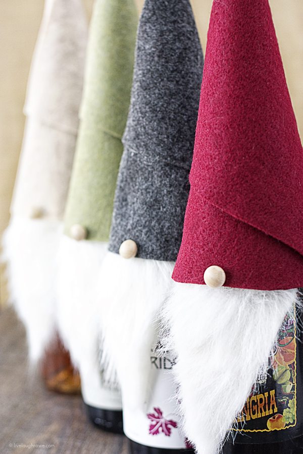 Super fun Gnome Wine Toppers made with felt and faux fur! Love it. www.livelaughrowe.com #gnome #winetopper