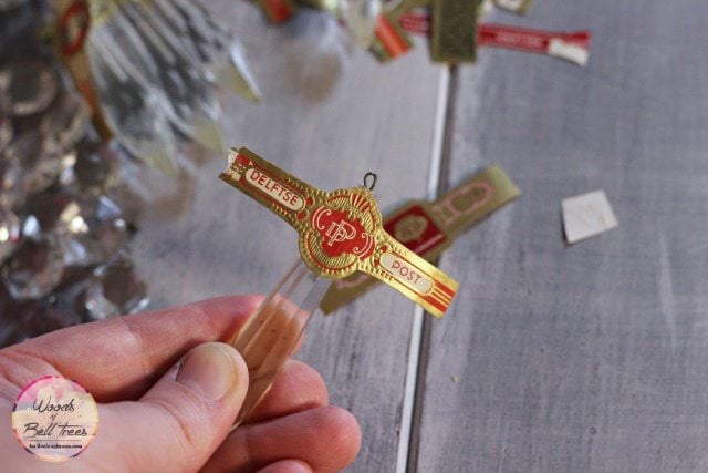 Placing the cigar band onto the chandelier crystal.