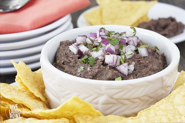 A quick Black Bean Dip that is SOOO good! Puréed goodness made of beans, onion, vinegar, orange juice, cilantro, oil, garlic and cumin. Recipe at livelaughrowe.com
