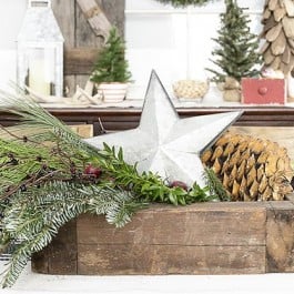 Lovely Christmas centerpiece using a vingtage box, greenery and a galvanized star. livelaughrowe.com
