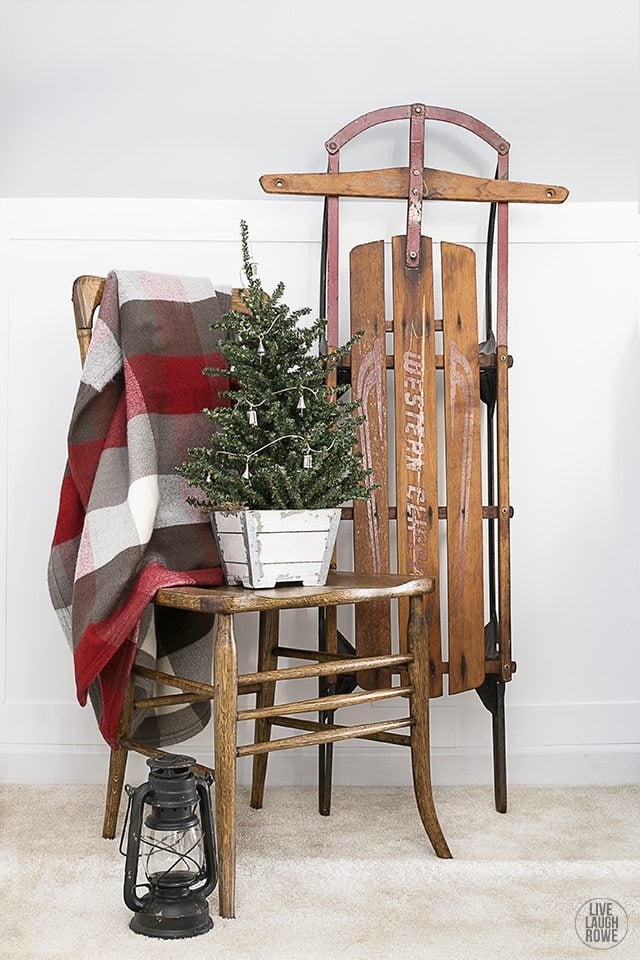 Woodland Christmas Home Tour. Love this corner vignette displaying a tree with an old sled. livelaughrowe.com