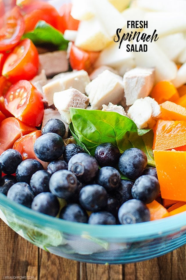 This Fresh Spinach Salad is a great summer salad, packed with chicken, fruits and vegetables. livelaughrowe.com