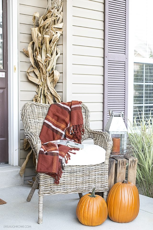 Fall Front Porch Decor to inspire you! Colorful Pumpkins, Corn Husks and a lovely sitting area. livelaughrowe.com