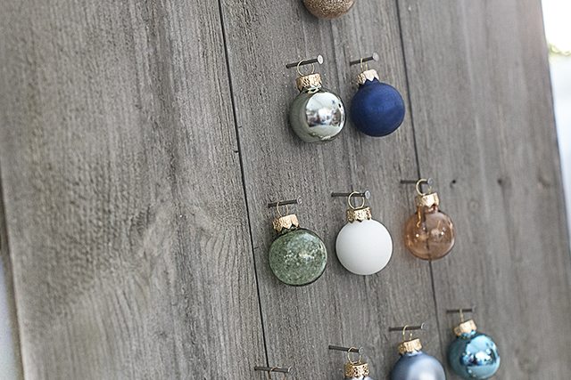 Step by step instructions on how to build a simple, rustic Shiplap Ornament Display. A great addition to your rustic, farmhouse holiday decor -- and you can change out the ornaments! livelaughrowe.com