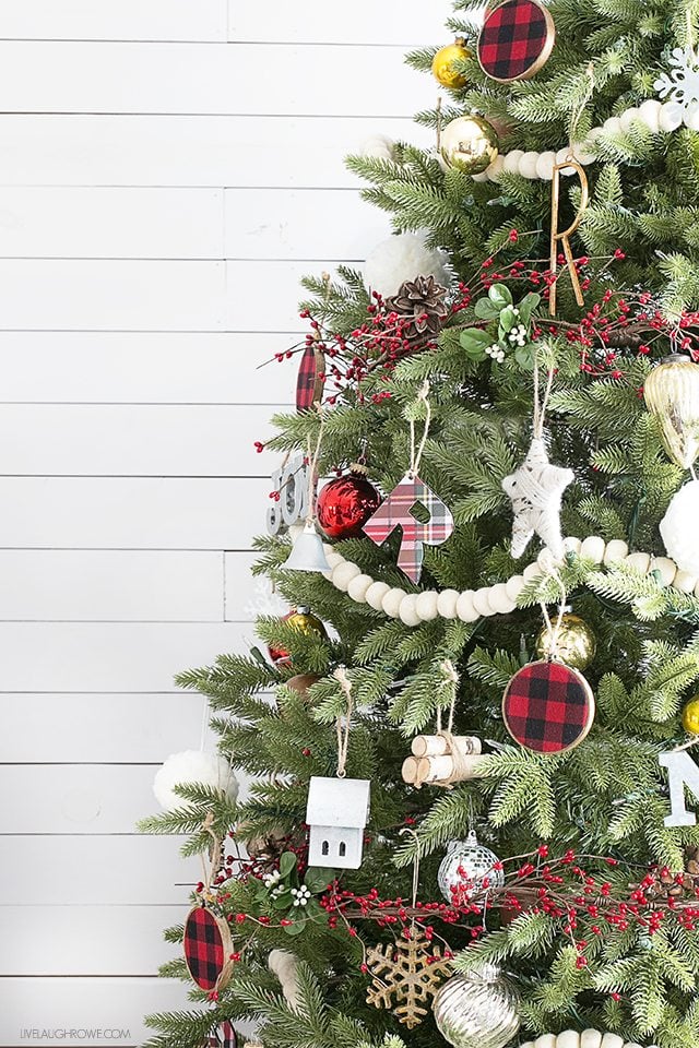 A simple rustic Christmas tree using wool felt balls for garland and splashes of plaid. Love the mix of the old and the new too. livelaughrowe.com