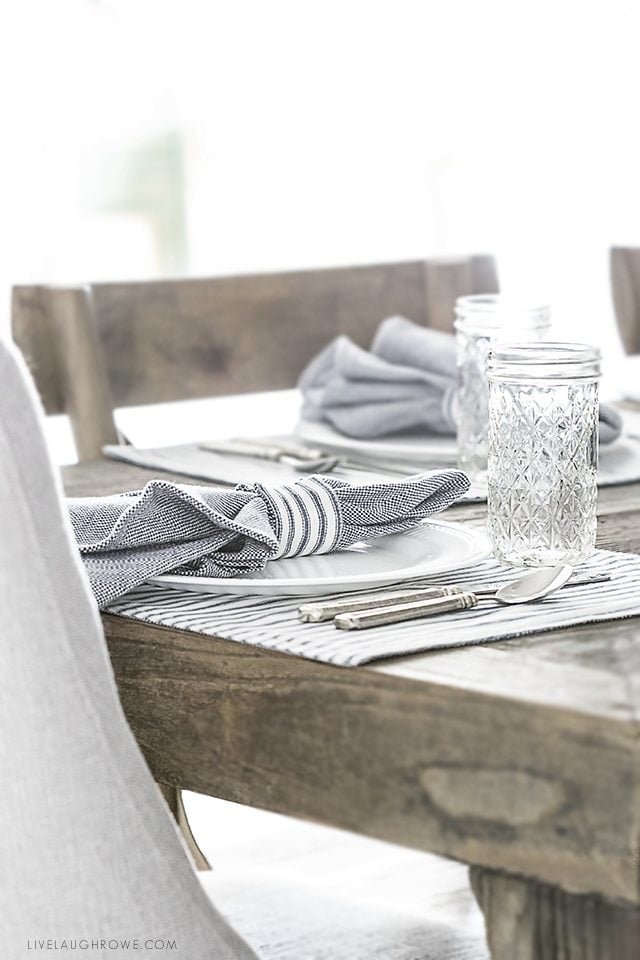 Beautiful farmhouse inspired tablescape using linens with blue ticking stripes. Simple, yet elegant in it's own way. livelaughrowe.com