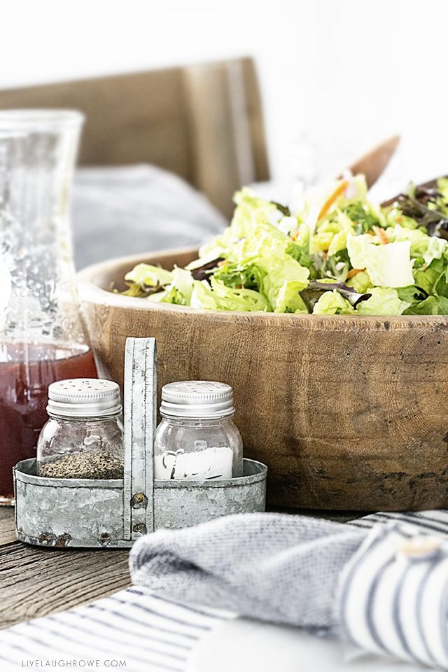 Beautiful farmhouse inspired tablescape using linens with blue ticking stripes. Simple, yet elegant in it's own way. livelaughrowe.com