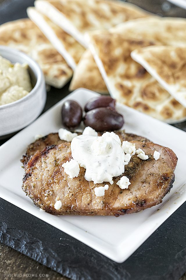 These greek pork chops are packed with flavor and are easy enough for a last-minute dinner! Serve with your favorite greek toppings and greek pita bread. livelaughrowe.com