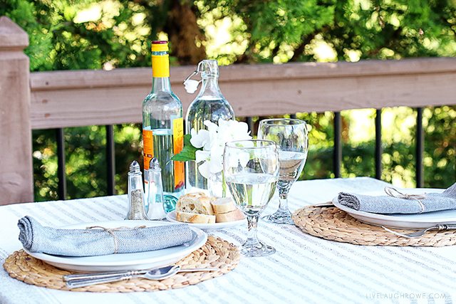 Enjoy a date night dining alfresco in your own backyard. This lifestyle blogger created a simple table setting to enjoy a delicious meal outdoors with her husband. More details at livelaughrowe.com