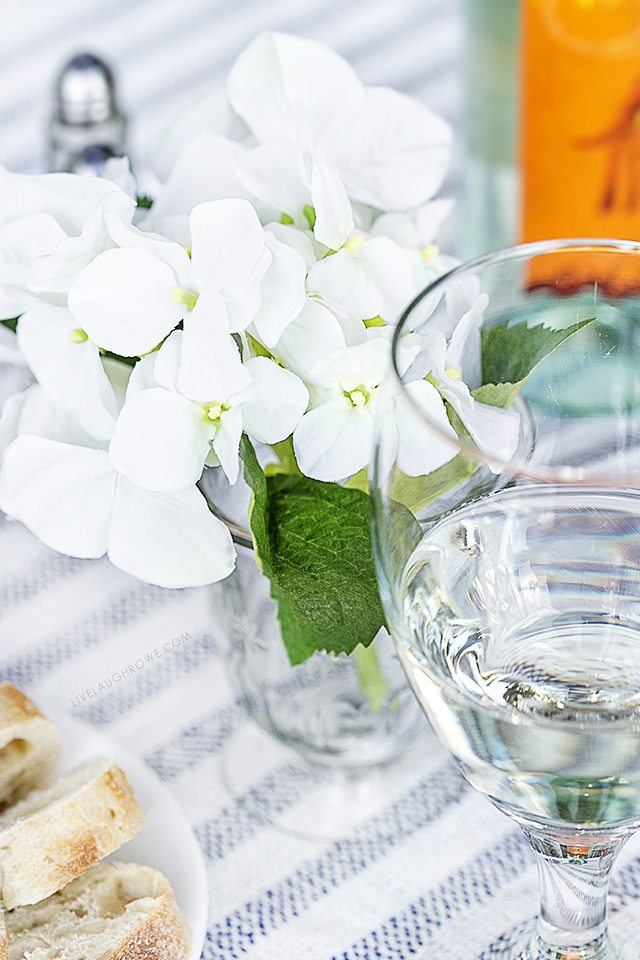 Enjoy a date night dining alfresco in your own backyard. This lifestyle blogger created a simple table setting to enjoy a delicious meal outdoors with her husband. More details at livelaughrowe.com