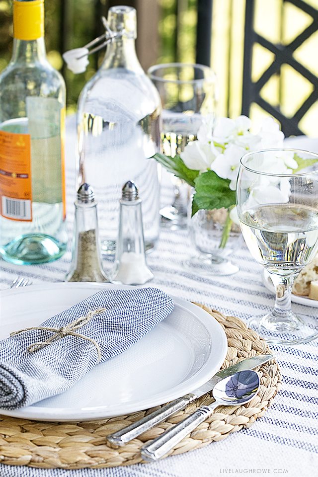 Enjoy a date night dining alfresco in your own backyard. This lifestyle blogger created a simple table setting to enjoy a delicious meal outdoors with her husband. More details at livelaughrowe.com