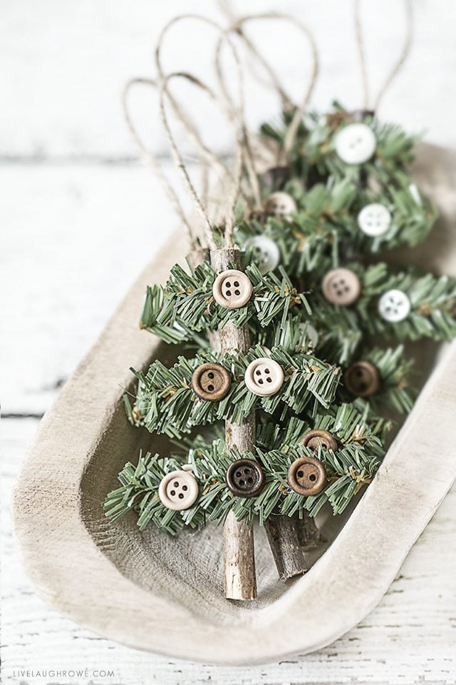 Kelly of Live Laugh Rowe created this simple, rustic Holiday Ornament using a stick, faux pine stem and buttons. This wooden tree would also make a great gift accessory! Find the full tutorial at livelaughrowe.com