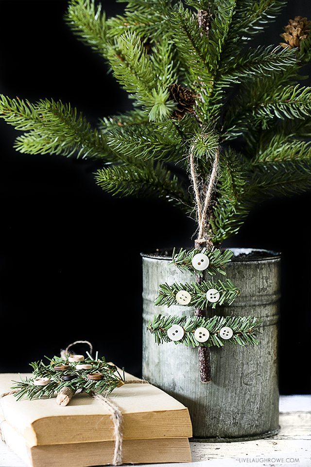 Kelly of Live Laugh Rowe created this simple, rustic Holiday Ornament using a stick, faux pine stem and buttons. This wooden tree would also make a great gift accessory! Find the full tutorial at livelaughrowe.com