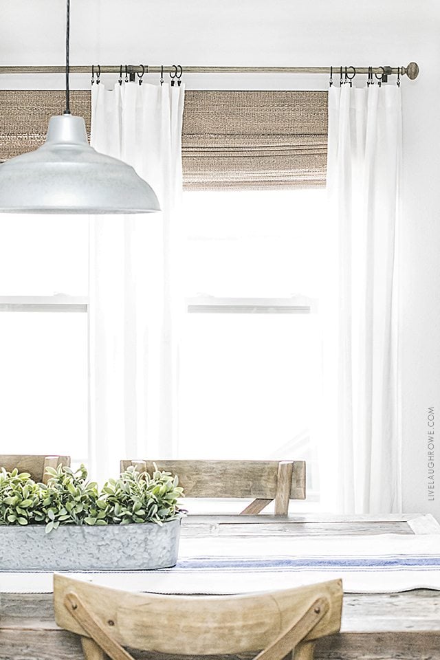 Beautiful neutral window treatments with farmhouse flare! From Levolor Natural shades to linen curtains, the space is bright and inviting. Learn more at livelaughrowe.com