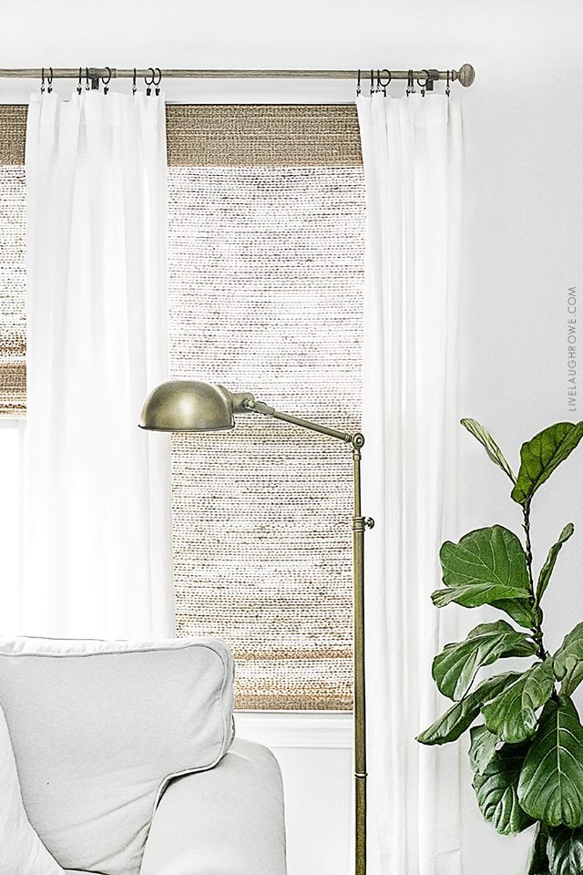 Beautiful neutral window treatments with farmhouse flare! From Levolor Natural shades to linen curtains, the space is bright and inviting. Learn more at livelaughrowe.com