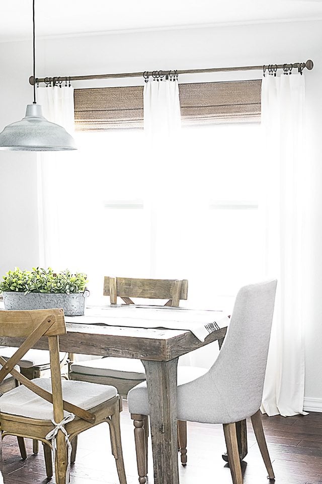 Beautiful neutral window treatments with farmhouse flare! From LEVOLOR® Natural shades to linen curtains, the space is bright and inviting. Learn more at livelaughrowe.com