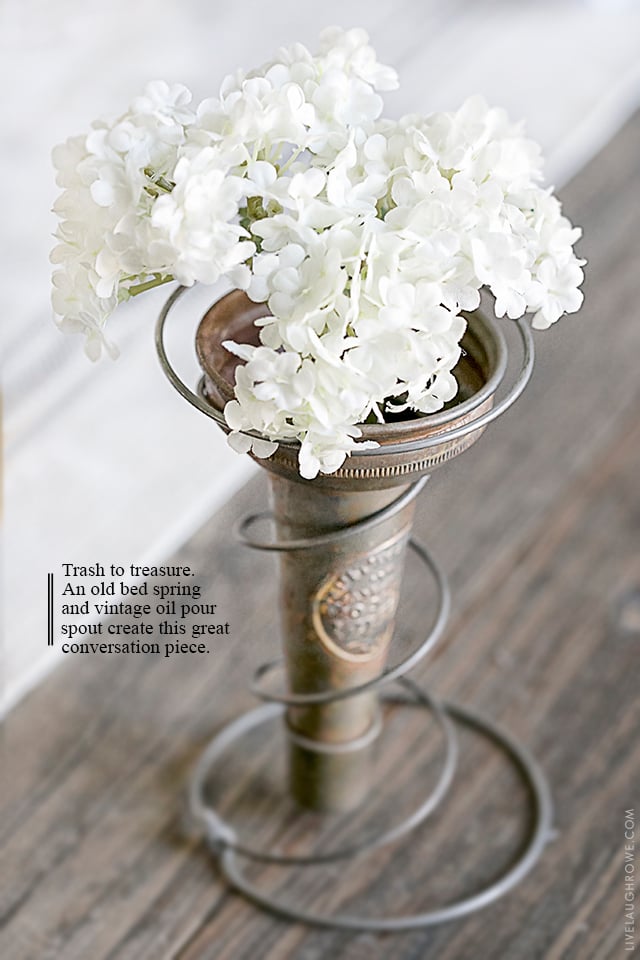 It's possible to take junk and turn it into something pretty fabulous (aka trash to treasure). Using a rusty old bed spring and a vintage oil pour spout, create this vase holder! It makes a great decorative piece or a centerpiece. Read more at livelaughrowe.com