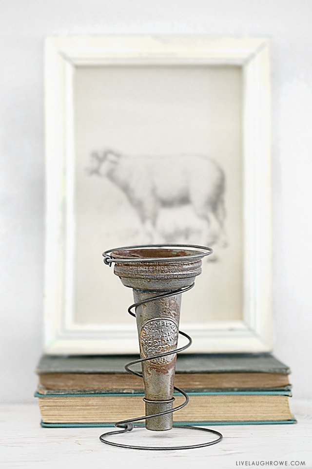 It's possible to take junk and turn it into something pretty fabulous (aka trash to treasure). Using a rusty old bed spring and a vintage oil pour spout, I created a vase holder! It makes a great decorative piece or a centerpiece. Read more at livelaughrowe.com