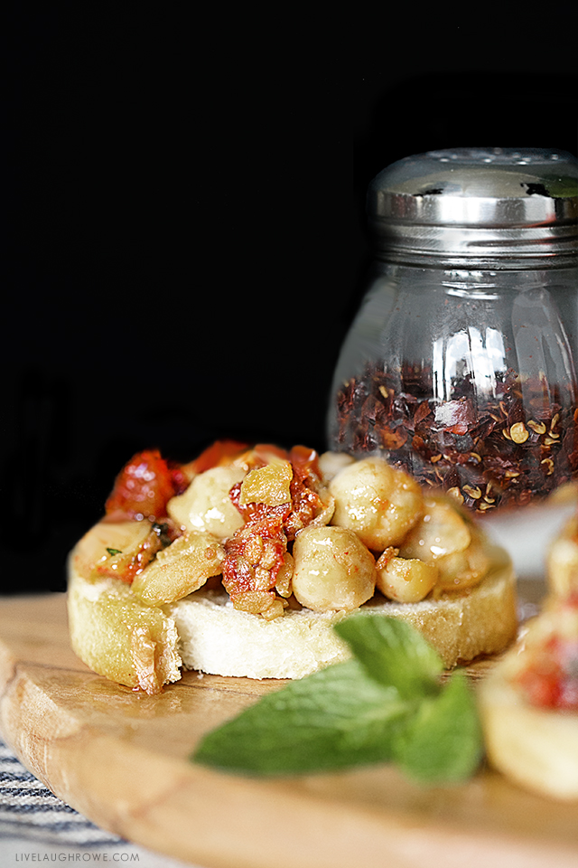 Savory Chickpea Crostini with Sun-Dried Tomatoes and Mint. This recipe makes a delicious snack or appetizer. Recipe at livelaughrowe.com