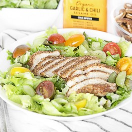 Delicious Mediterranean dish with pecan-crusted chicken on salad greens. Add some grapes and a drizzle of Spectrum® Organic Garlic & Chili Sesame Oil for twist of sweet and spicy! Recipe at livelaughrowe.com