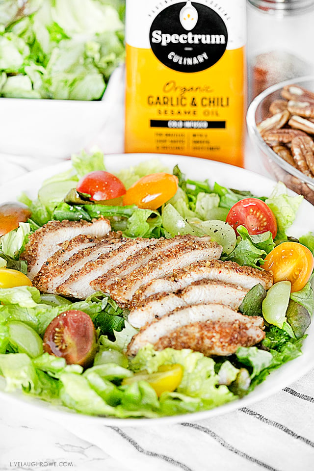 Delicious Mediterranean dish with pecan-crusted chicken on salad greens. Add some grapes and a drizzle of Spectrum® Organic Garlic & Chili Sesame Oil for twist of sweet and spicy! Recipe at livelaughrowe.com