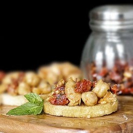 Savory Chickpea Crostini with Sun-Dried Tomatoes and Mint. This recipe makes a delicious snack or appetizer. Recipe at livelaughrowe.com