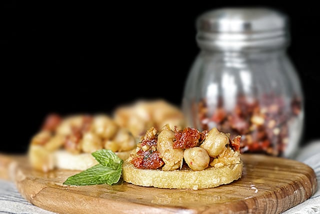 Savory Chickpea Crostini with Sun-Dried Tomatoes and Mint. This recipe makes a delicious snack or appetizer. Recipe at livelaughrowe.com