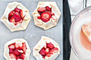 Adding strawberry filling and folding dough to finalize the Strawberry Galettes. Full recipe and directions at livelaughrowe.com