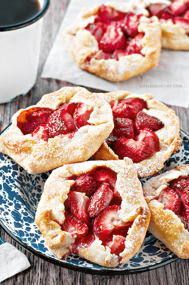 The free form flaky pie crust wrapped around the fruit makes these Mini Strawberry Galettes as easy as pie! A simple rustic, summer dessert . Recipe at livelaughrowe.com