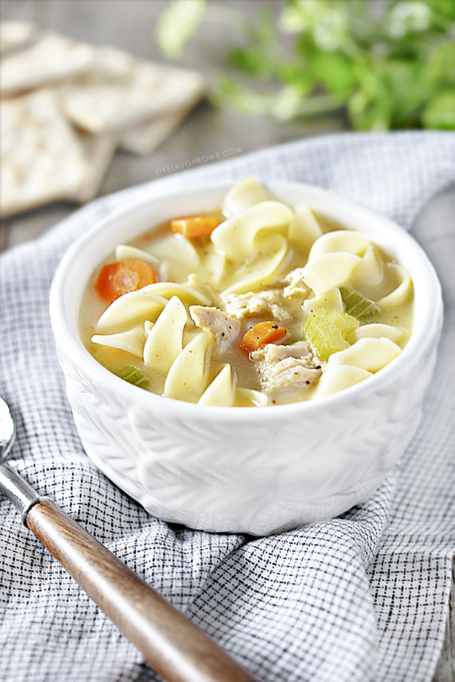 Bowl of Crockpot Chicken Noodle Soup, Napkin, Crackers and Spoon