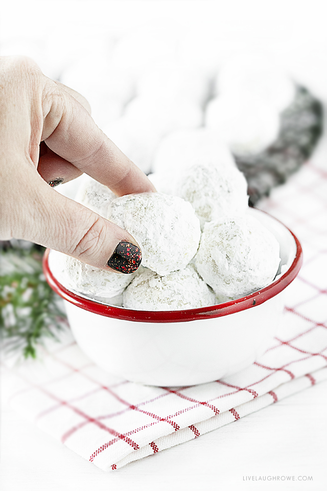 Hand reaching for a Snowball Cookie