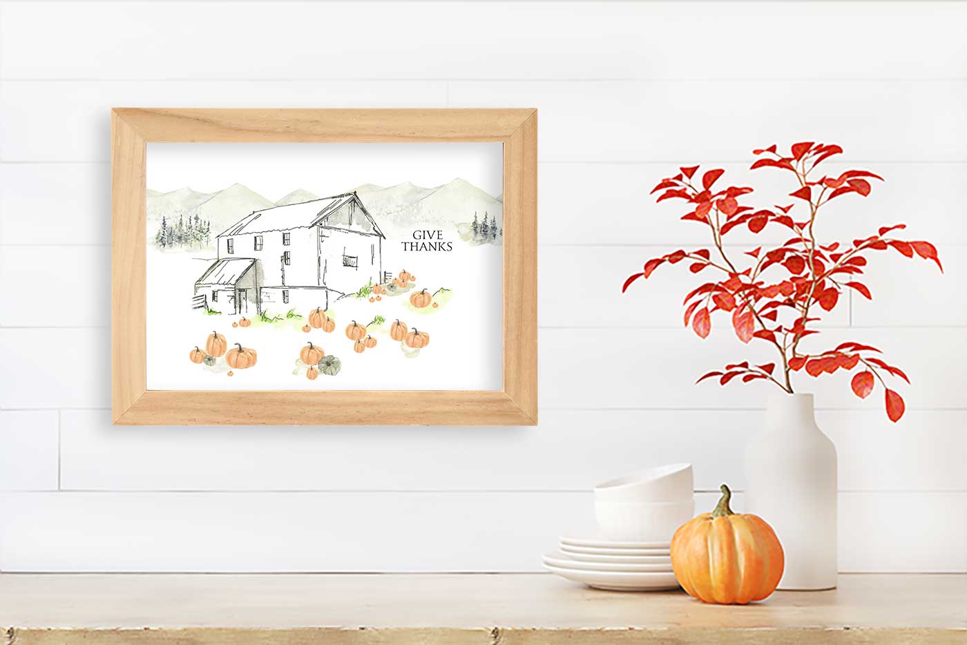 printable styled in a wooden frame surrounded by pumpkins and cozy fall decorations.