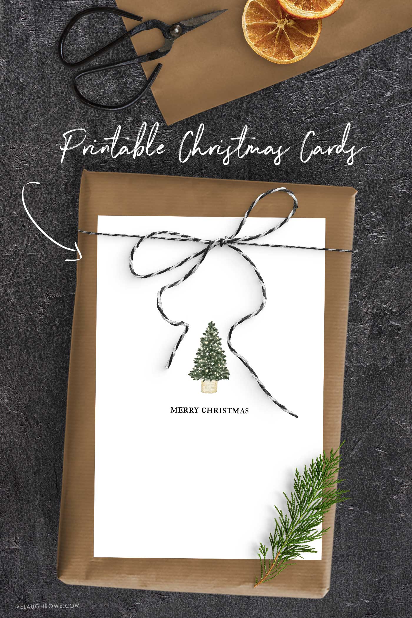Brown-paper wrapped present with black-and-white twine and a minimalist Christmas tree printable card.