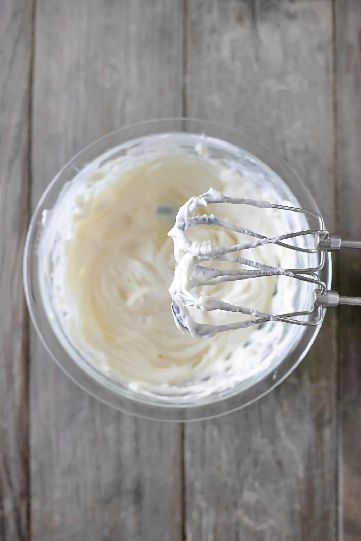 Mixing cream cheese and fluff with a hand mixer