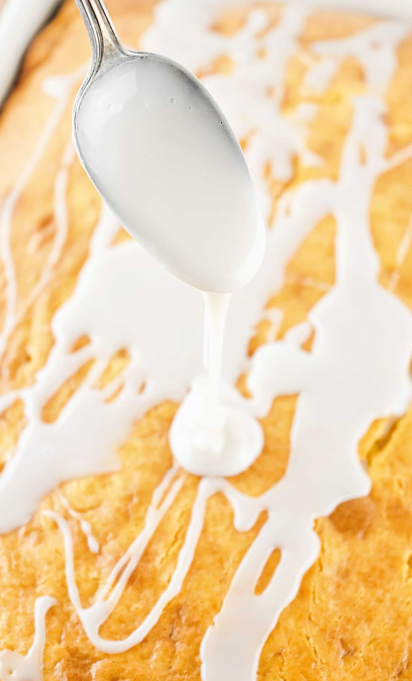 pouring glaze over cake