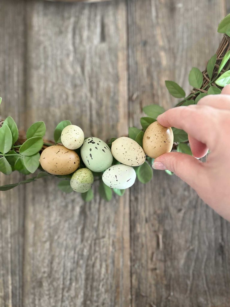 tutorial picture. attaching artificial eggs to wreath form. diy spring wreath