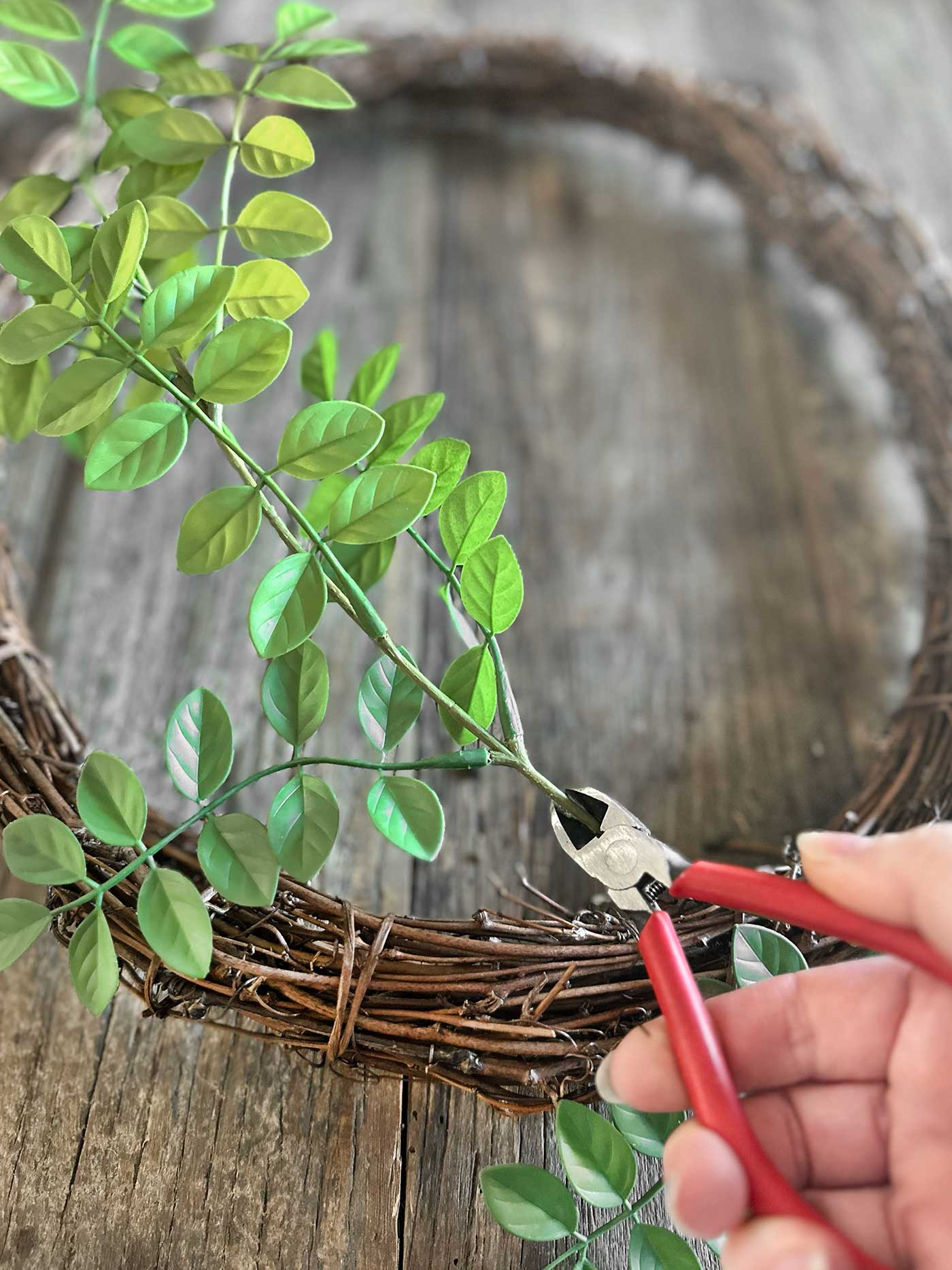 using wire cutters to cut a floral stem