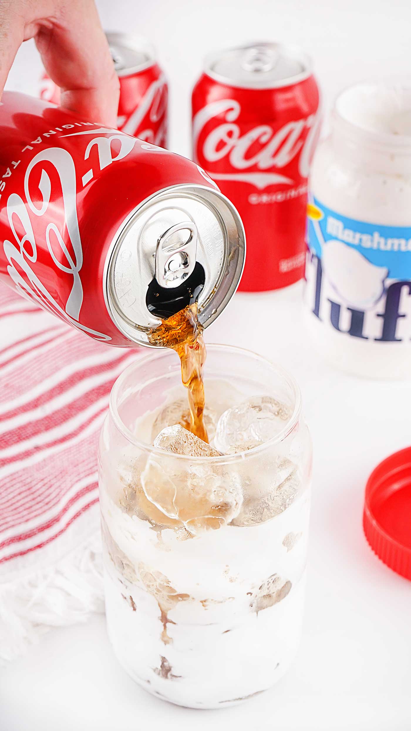 pouring coke over ice and fluff for Marshmallow Coke