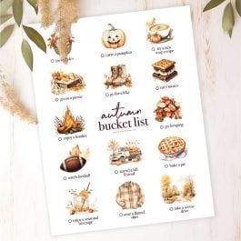 autumn bucket list printable on wood with fall greenery