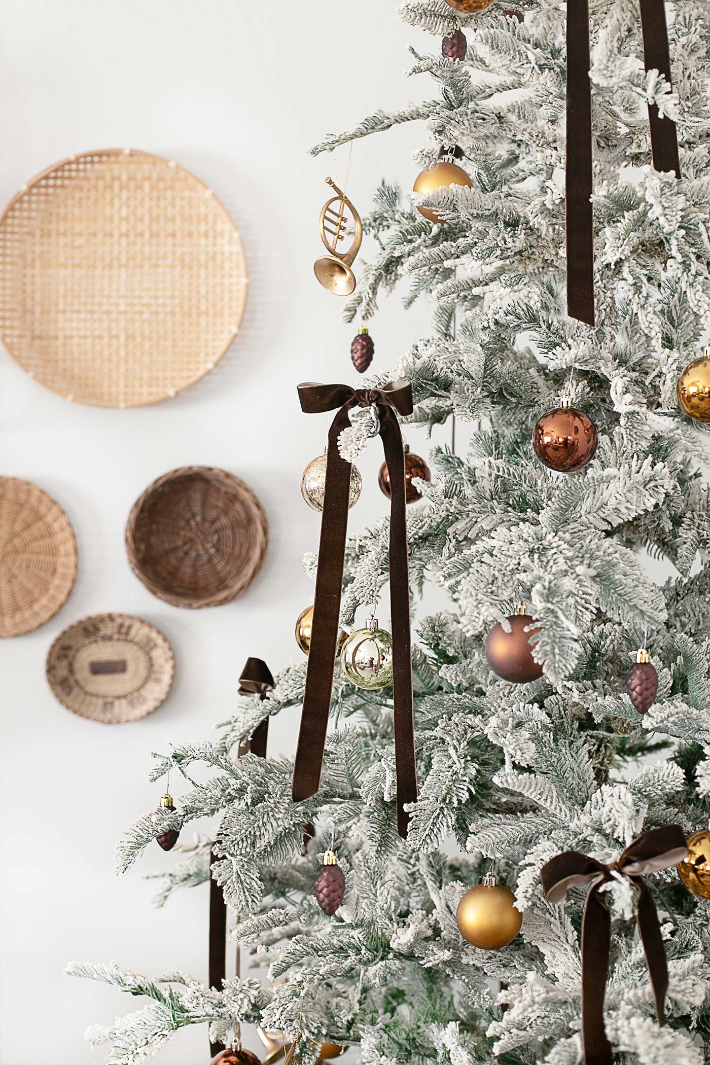 Brown velvet ribbon and other ornaments on a flocked tree