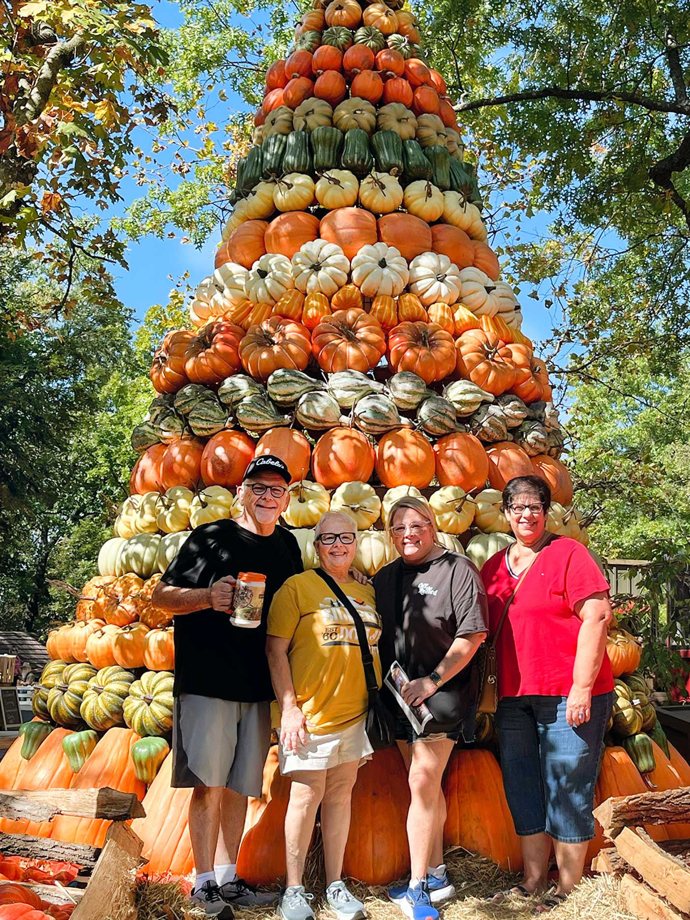 pumpkin tower with four individuals standing in front of it at Silver Dollar City in Branson, MO