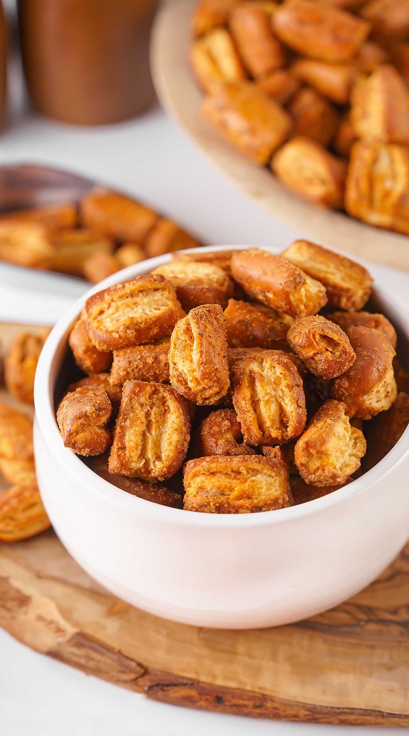 white bowl with pretzel bites sitting on a wood cutting board