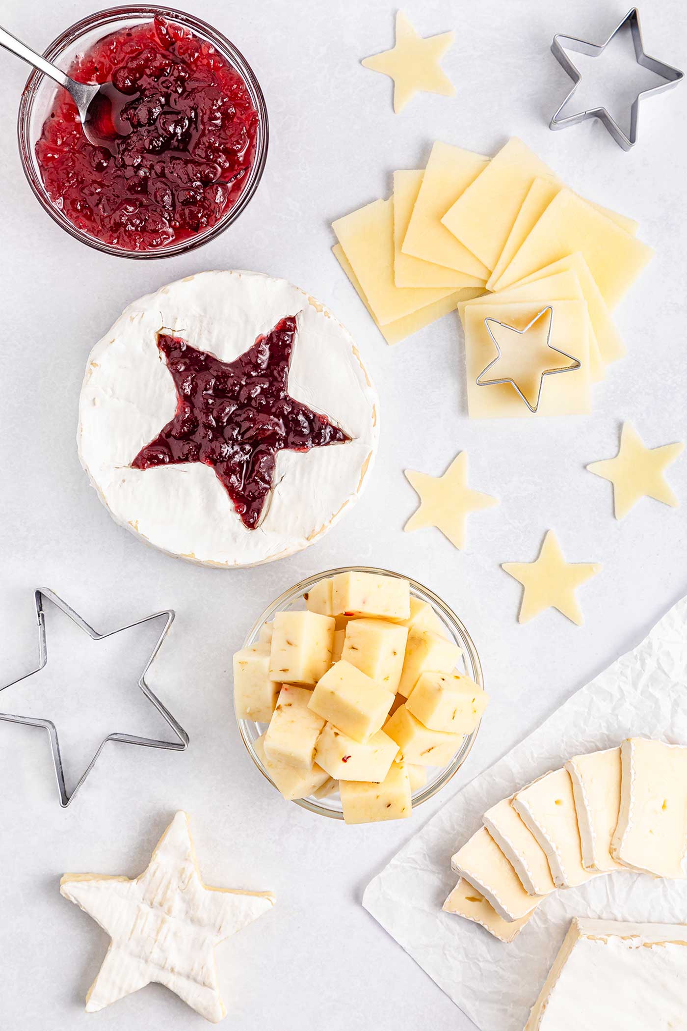 blocks and slices of cheese with star cookie cutters